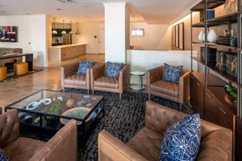 a living room with leather furniture and a glass coffee table